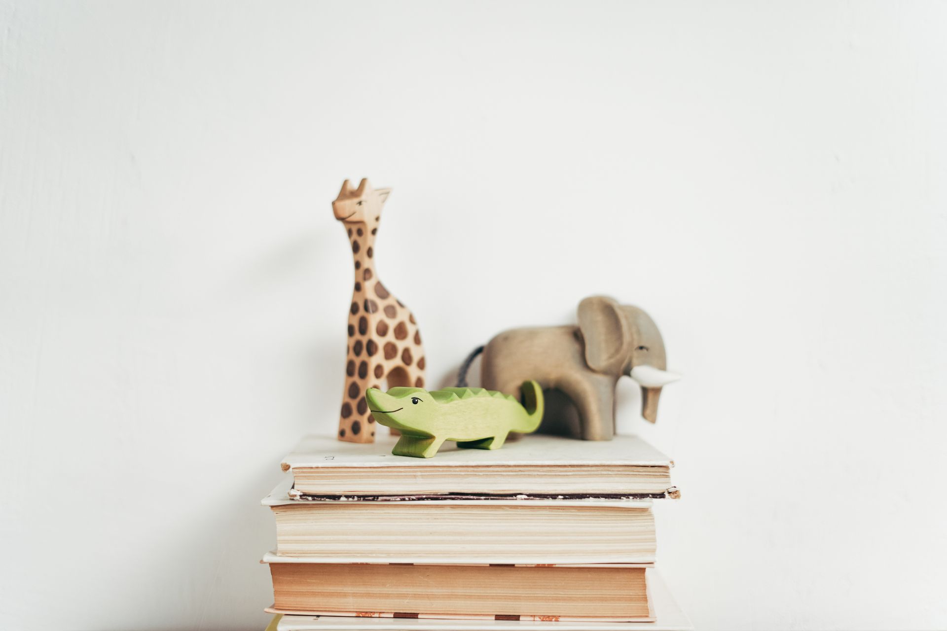 Houten speelgoed op boeken.